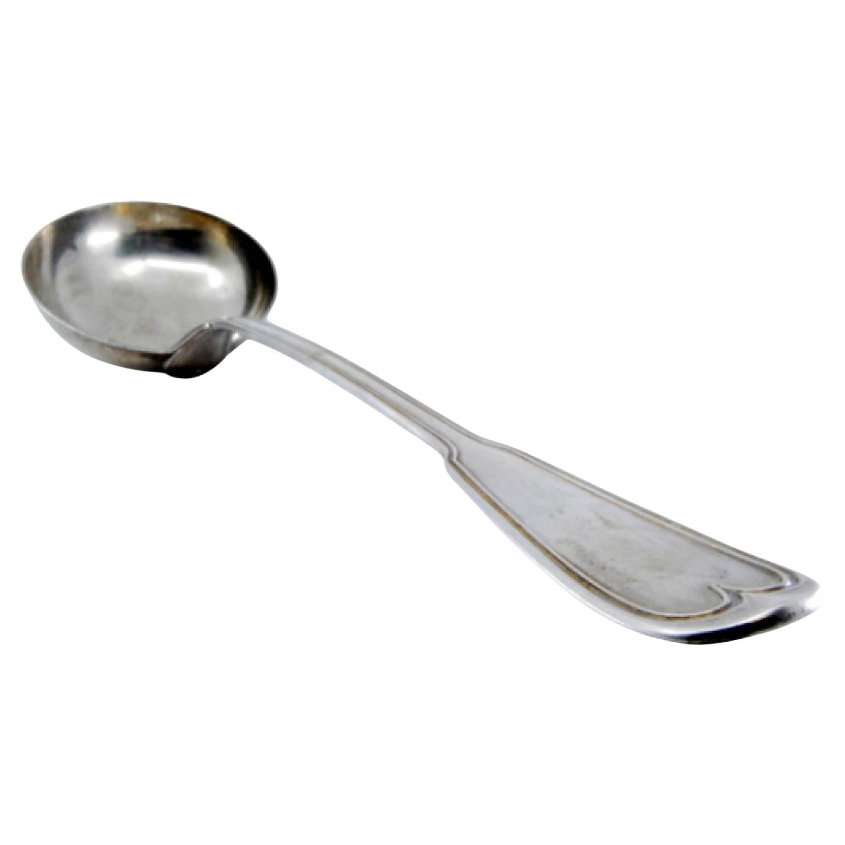 Silver soup ladle with a frieze along the handle to be shipped
