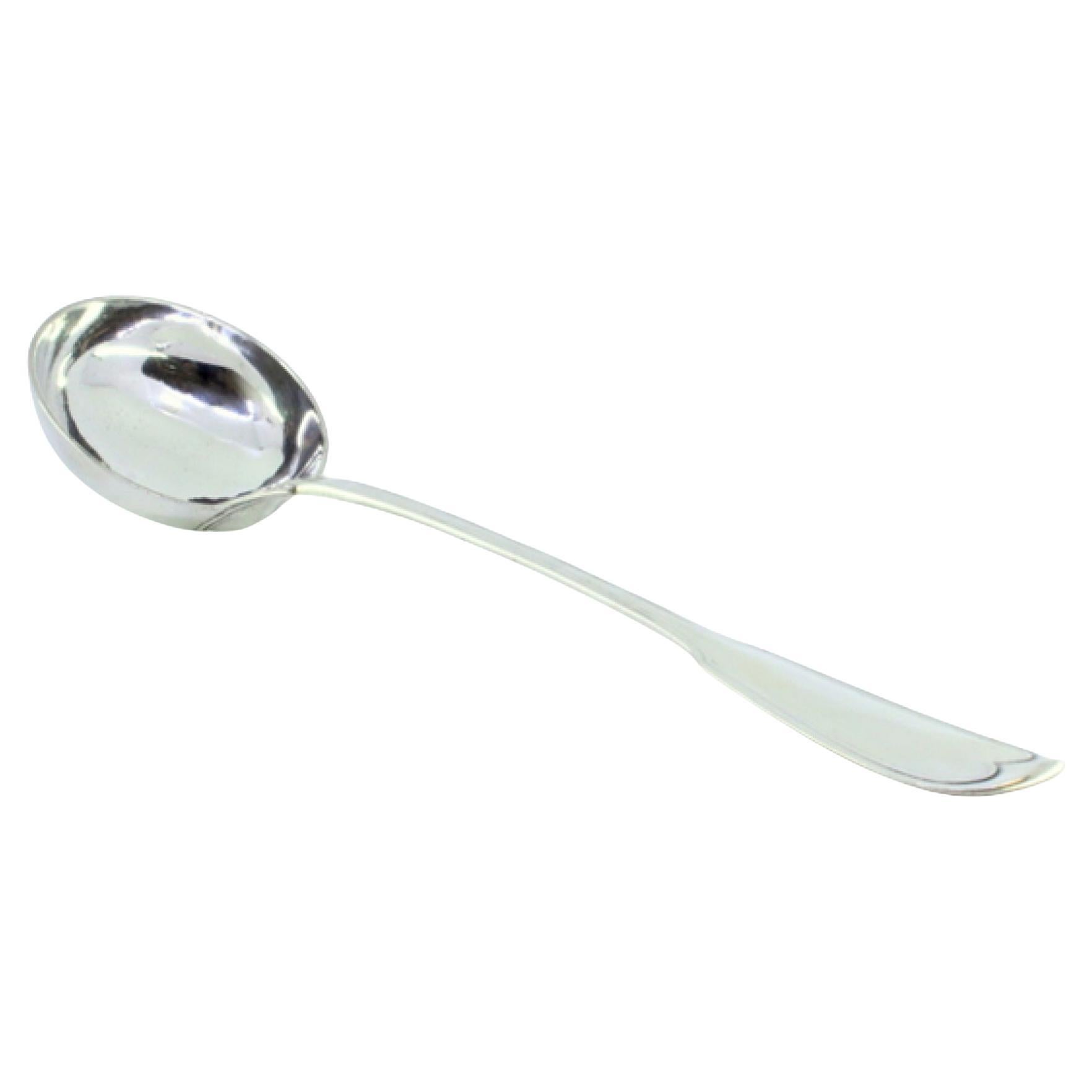 Silver soup ladle with a strip along the handle
