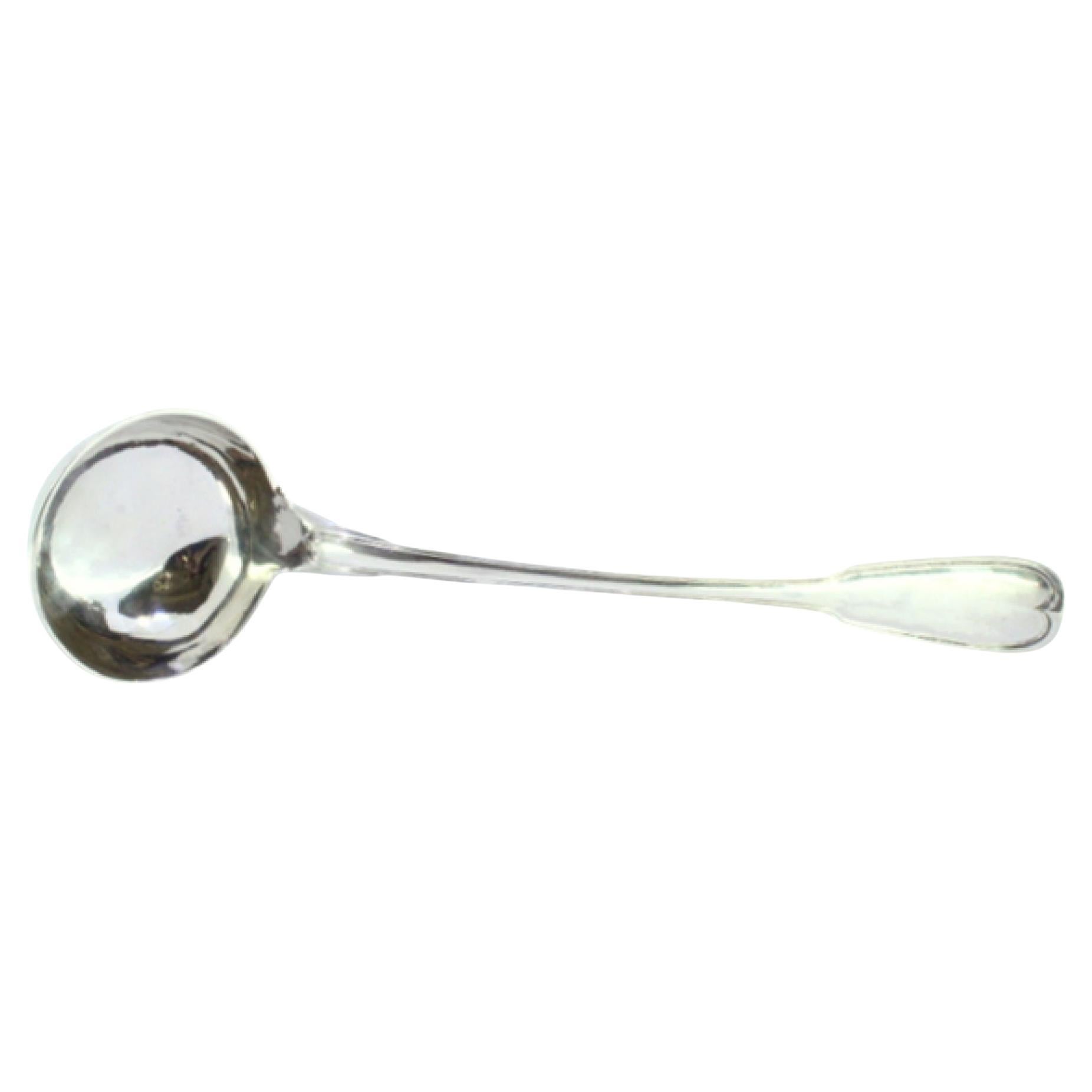 Silver soup ladle with a strip along the handle