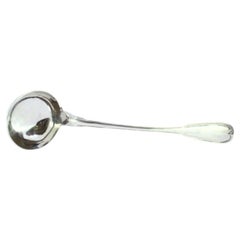 Silver soup ladle with a strip along the handle