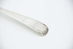 Silver soup ladle with Caninhas-style grooves on the handle