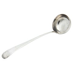 Silver soup ladle with Caninhas-style grooves on the handle