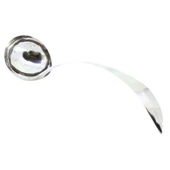 Silver soup ladle with curved handle trim