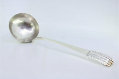 Silver soup ladle with embossed handle