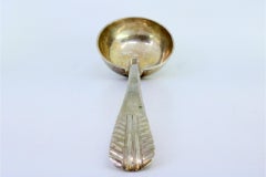 Silver soup ladle with embossed handle