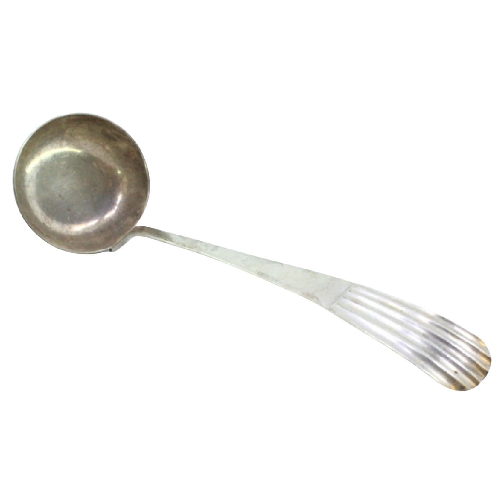 Silver soup ladle with embossed handle