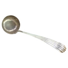 Silver soup ladle with embossed handle