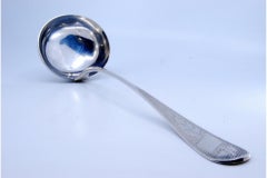 Silver soup ladle with floral motifs engraved on the handle and a monogram card