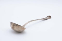 Silver soup ladle with friezes along the handle and relief