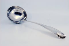 Silver soup ladle with friezes along the handle in relief with a ladle