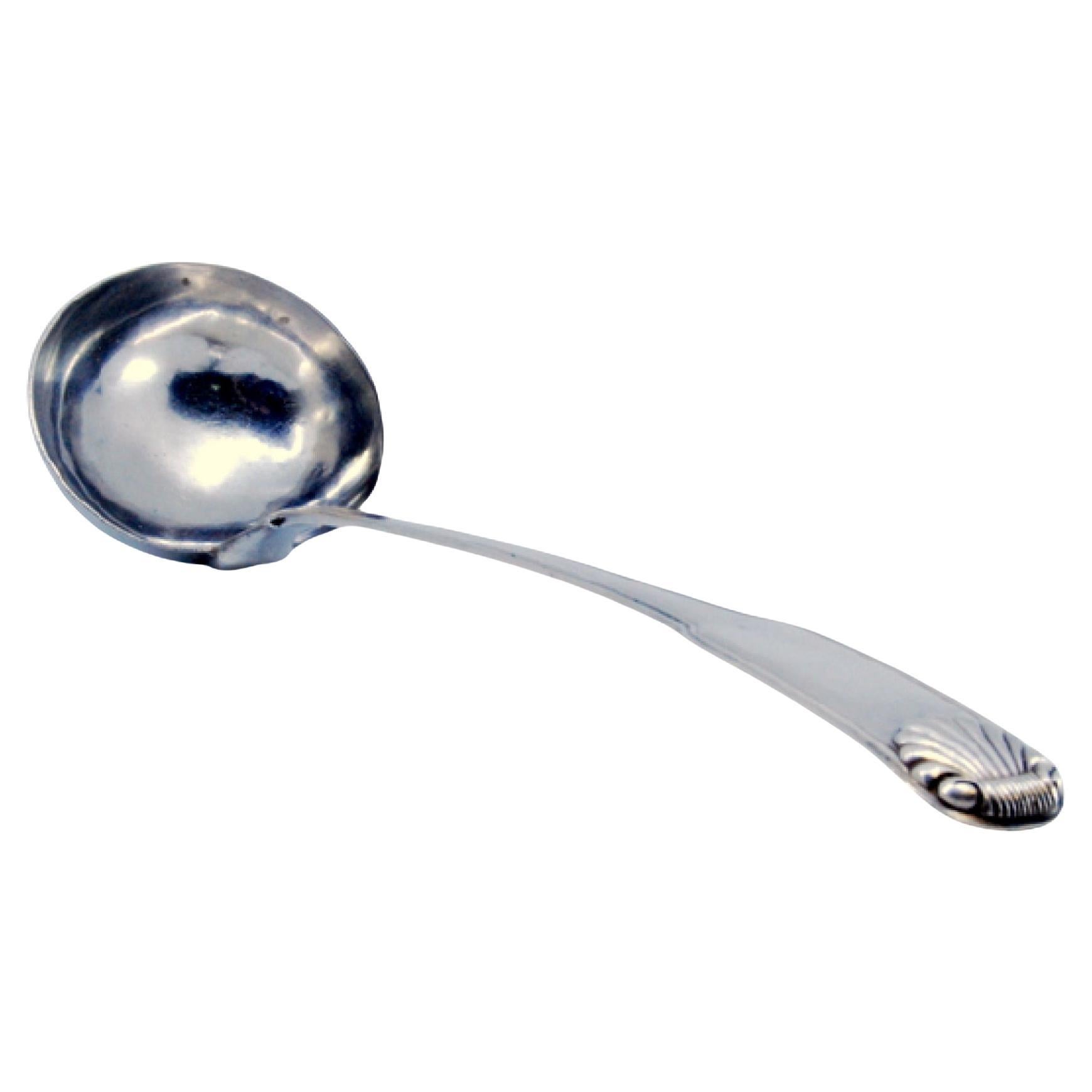 Silver soup ladle with friezes along the handle in relief with a ladle