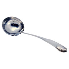 Silver soup ladle with friezes along the handle in relief with a ladle