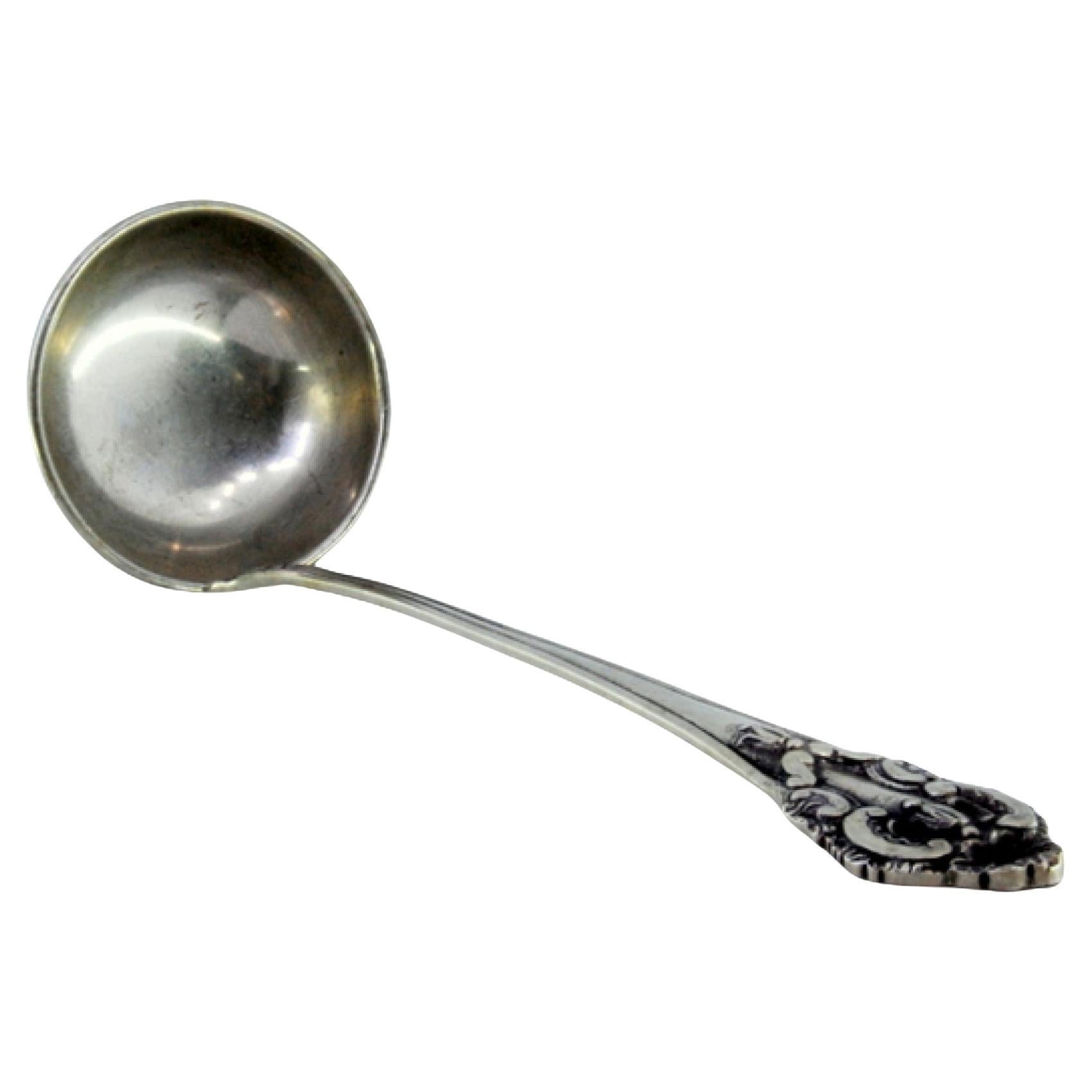 Silver soup ladle with friezes and reliefs on the handle For Sale