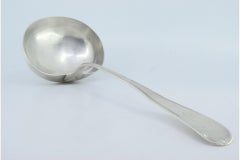 Silver soup ladle with grooves along the handle