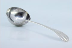 Silver soup ladle with grooves along the handle