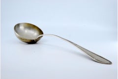 Mestolo da zuppa in argento con scanalature lungo il manico