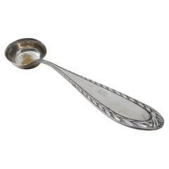Silver soup ladle with grooves along the handle