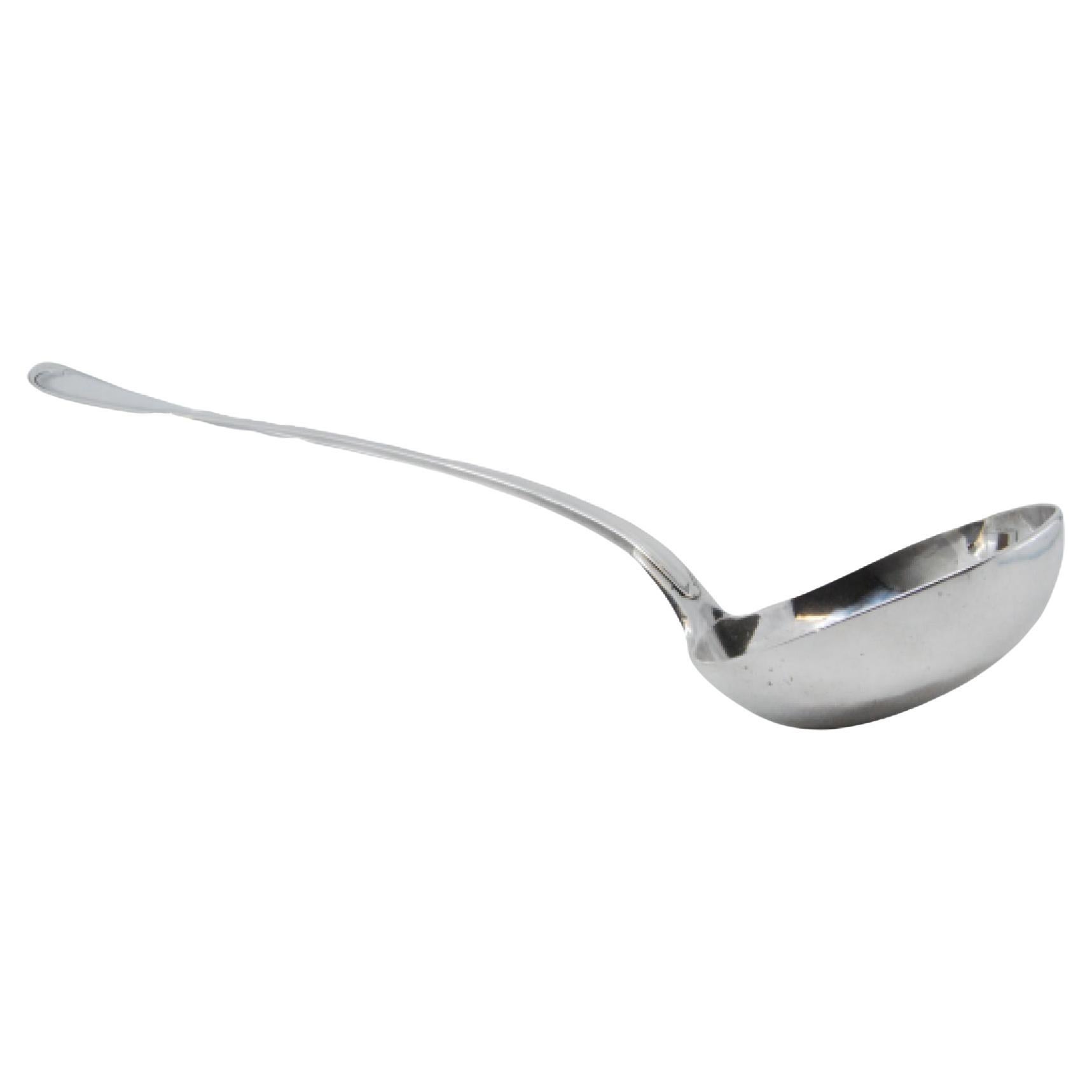 Silver soup ladle with grooves along the handle
