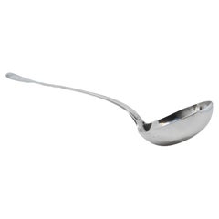 Silver soup ladle with grooves along the handle