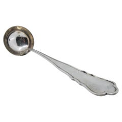 Silver soup ladle with grooves along the handle