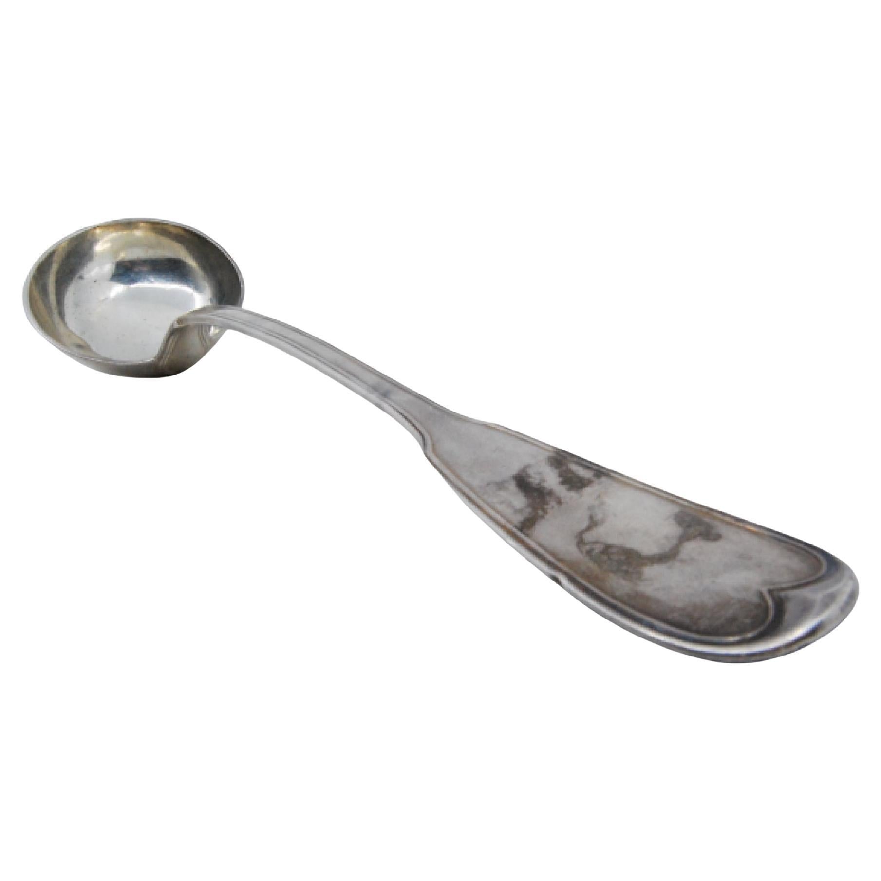 Silver soup ladle with grooves along the handle