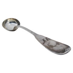 Silver soup ladle with grooves along the handle