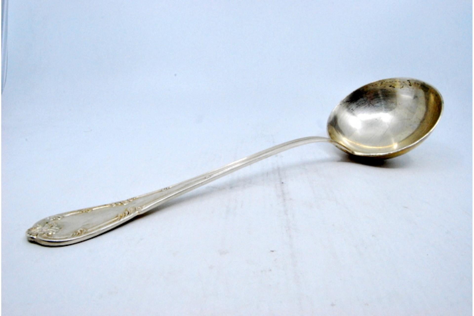 Silver soup ladle with grooves along the handle surrounding a monogram card Europeo en venta