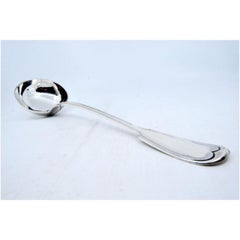 Silver soup ladle with grooves along the handle to be shipped