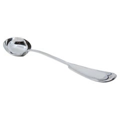 Silver soup ladle with grooves along the handle to be shipped