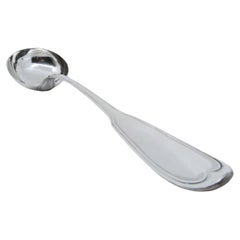 Silver soup ladle with grooves along the handle to be shipped
