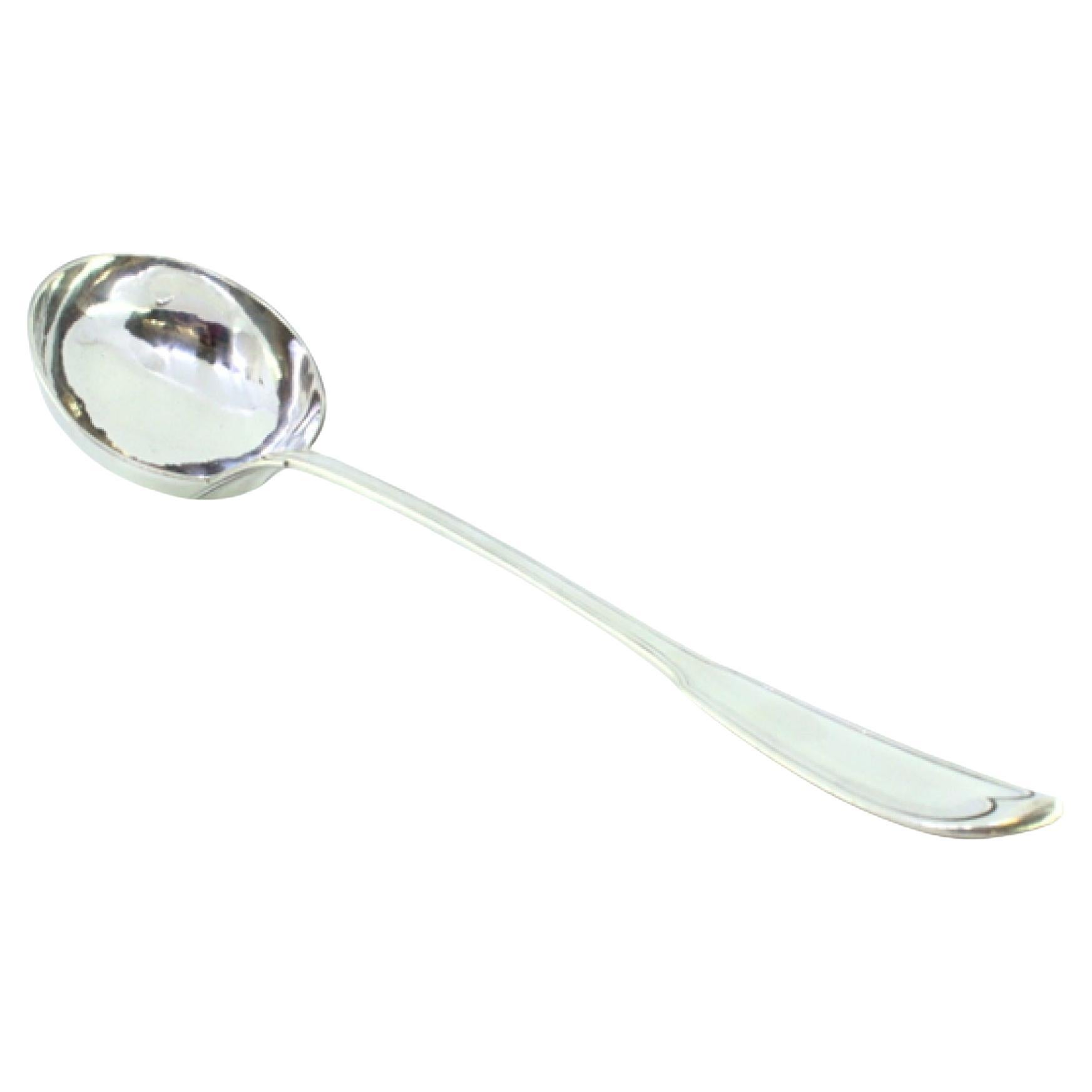 Silver soup ladle with grooves along the handle to be shipped