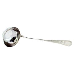 Silver soup ladle with guilloche handle and monogram card