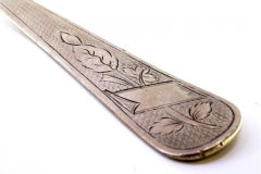 Silver soup ladle with guilloche pattern and floral monogram cartouche