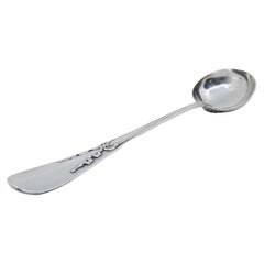 Silver soup ladle with raised loops along the handle