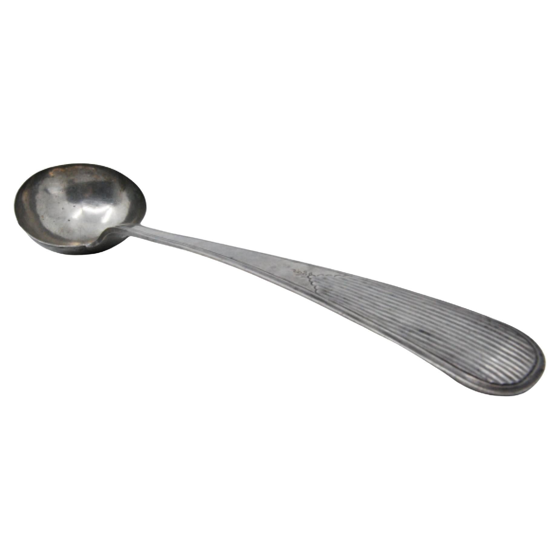 Silver soup ladle with reed-grooved handle and engraved bowl exterior