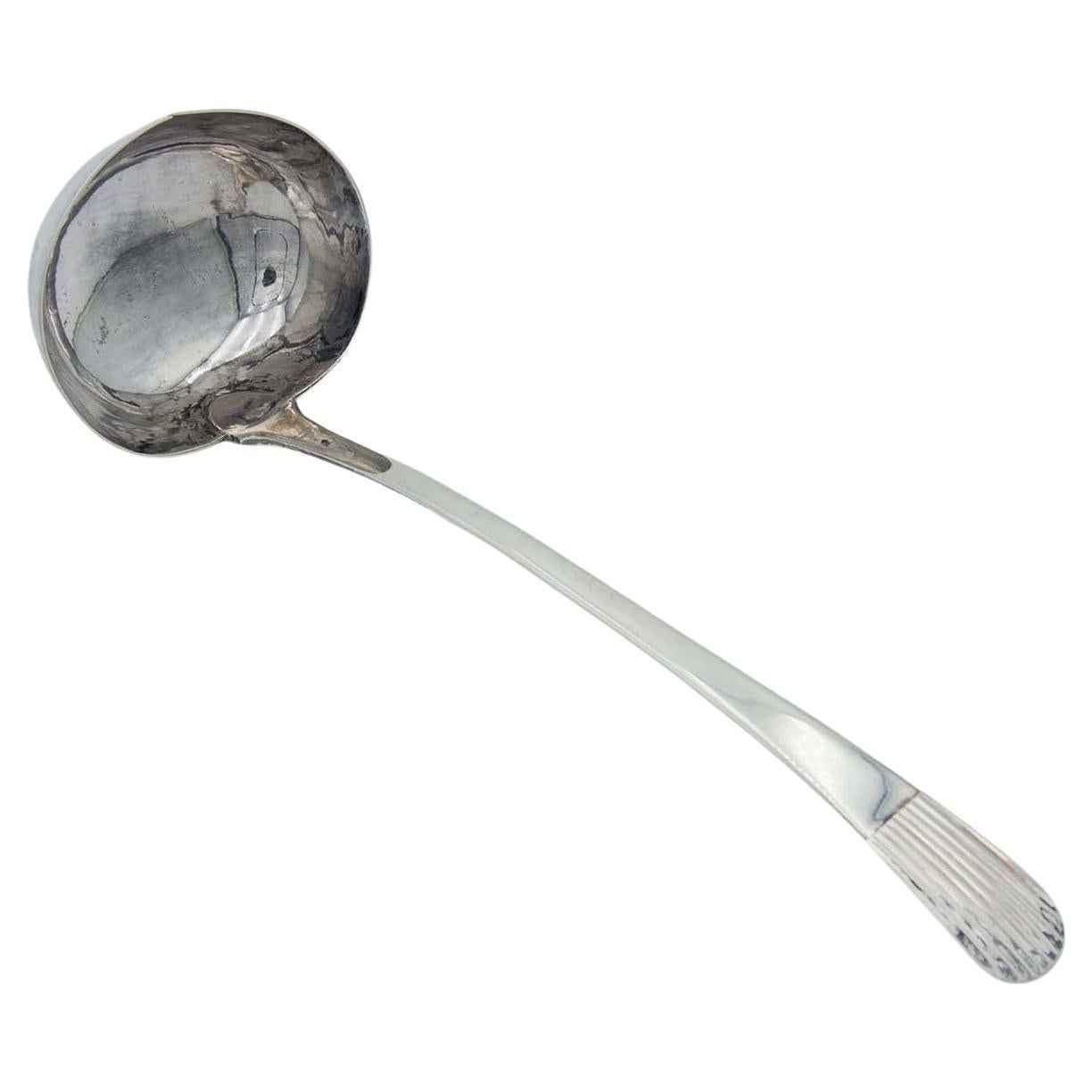 Silver soup ladle with reed-style handle