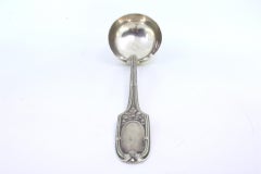 Silver soup ladle with relief friezes and monogram on the handle