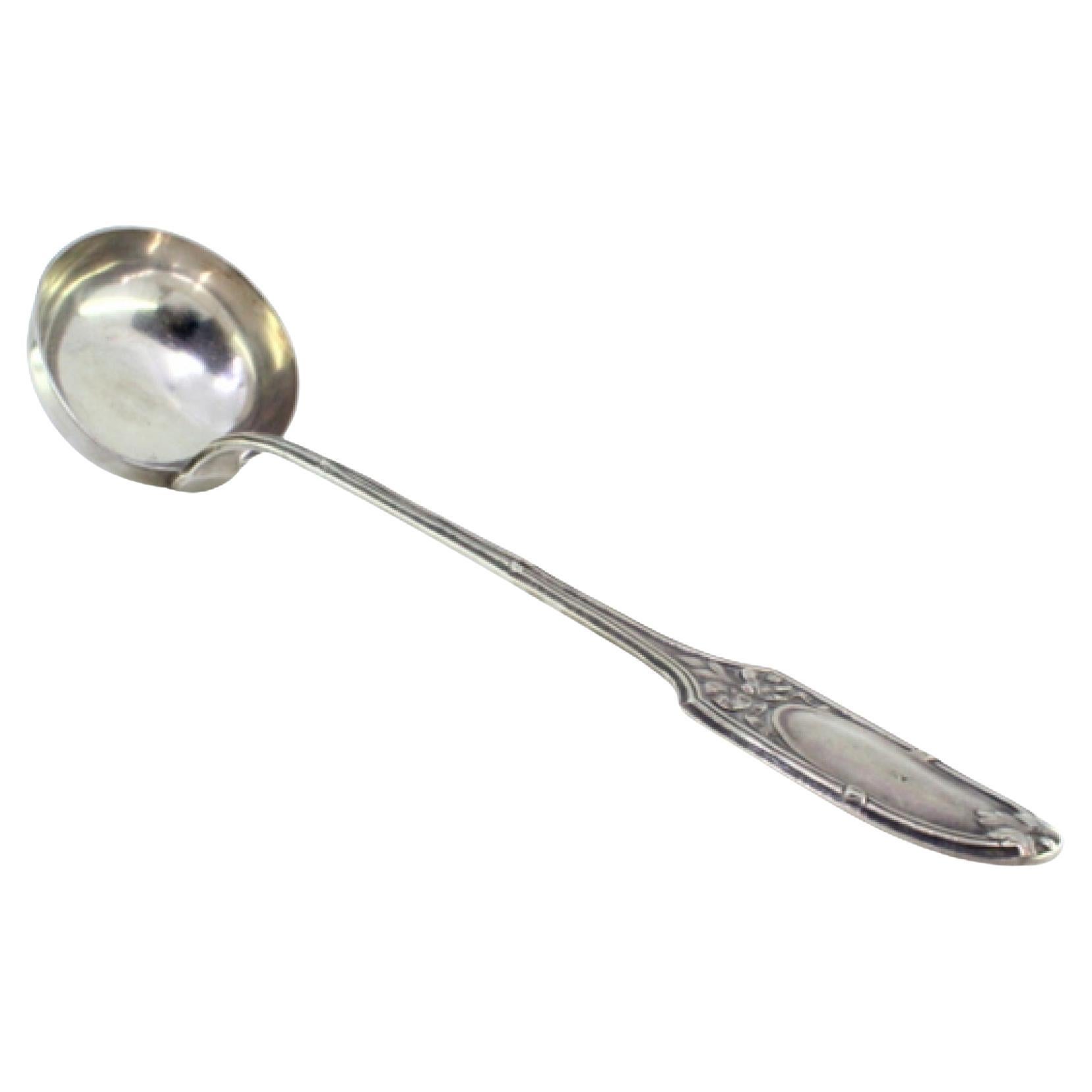 Silver soup ladle with relief friezes and monogram on the handle