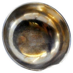 Silver soup ladle with reliefs and friezes on the handle