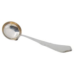 Silver soup ladle with scalloped handle and trim