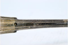 Silver soup ladle with scalloped handle