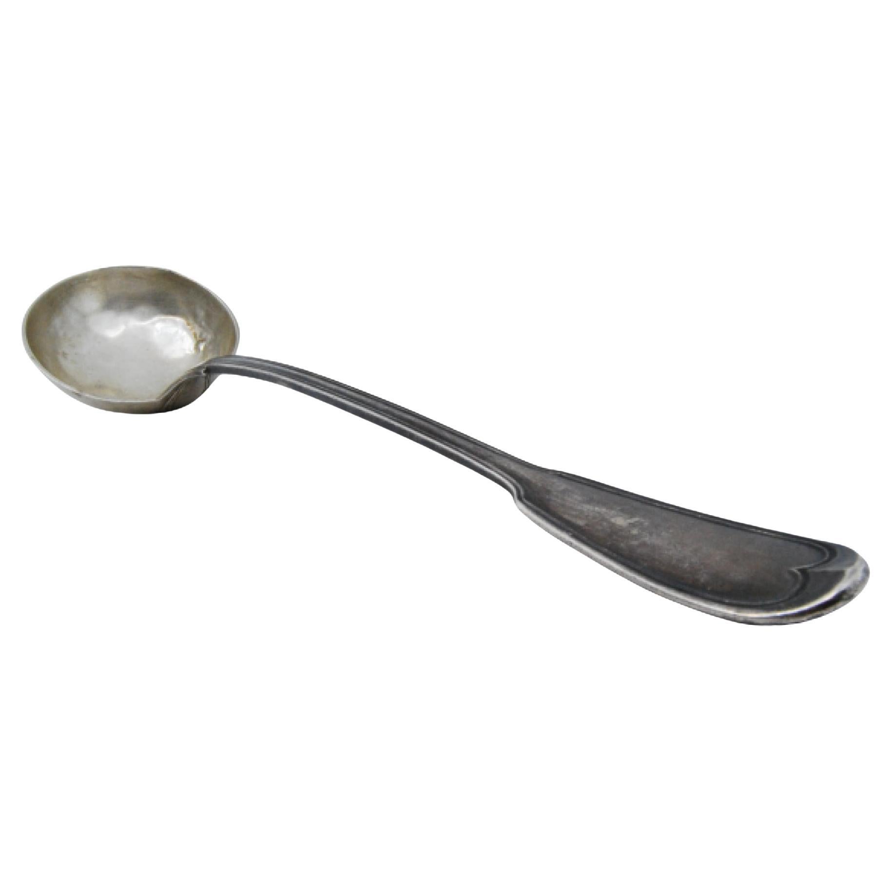 Silver soup ladle with scalloped handle