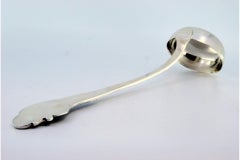 Silver soup ladle with wavy reliefs on the handle, surrounding a monogram card
