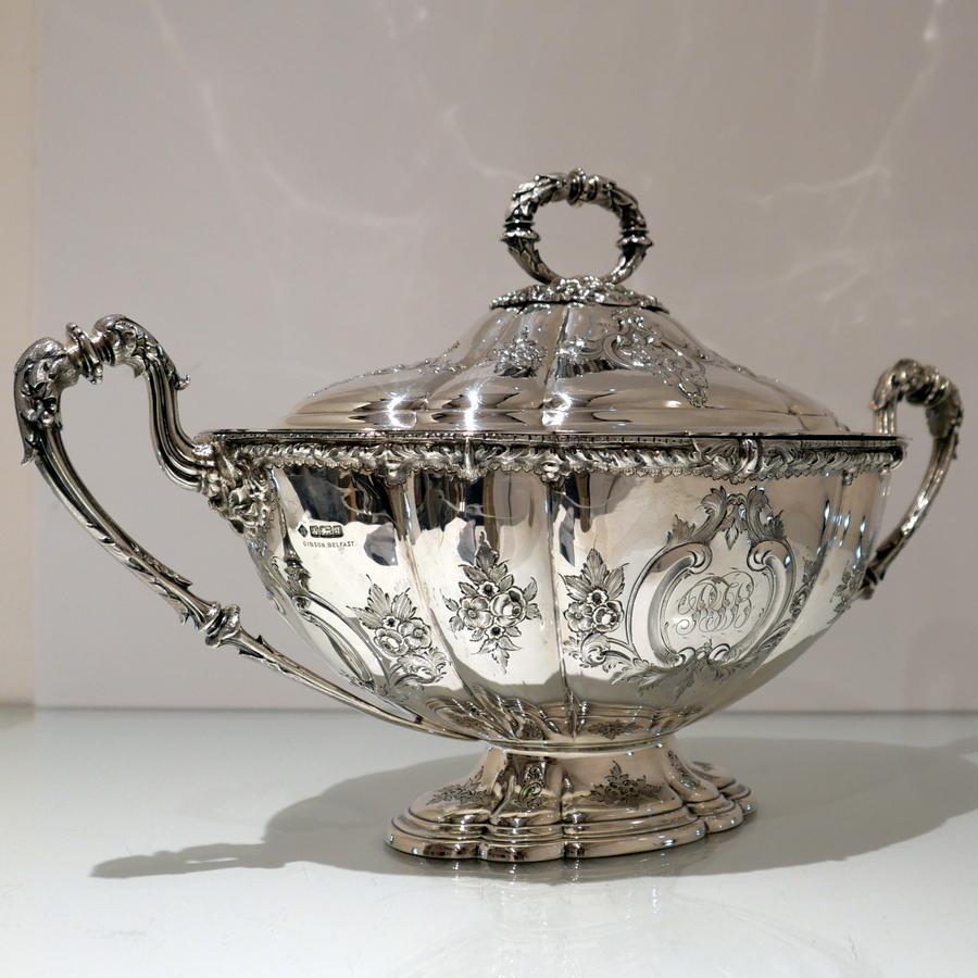 A truly stunning and incredibly large shaped oval sterling silver soup tureen and cover decorated with stylish floral embellishments and two central cartouches in which sits contemporary a crest and bearing initials for importance. The detachable