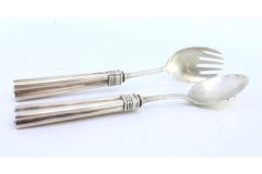 Silver spaghetti and serving spoons with reliefs and grooved handles