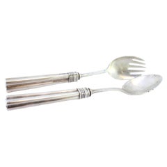 Silver spaghetti and serving spoons with reliefs and grooved handles