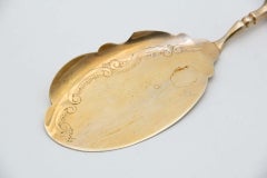 Silver spatula for desserts and sweets, golden and embossed