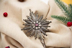 Silver splendor with raised floral motifs and lined red stone
