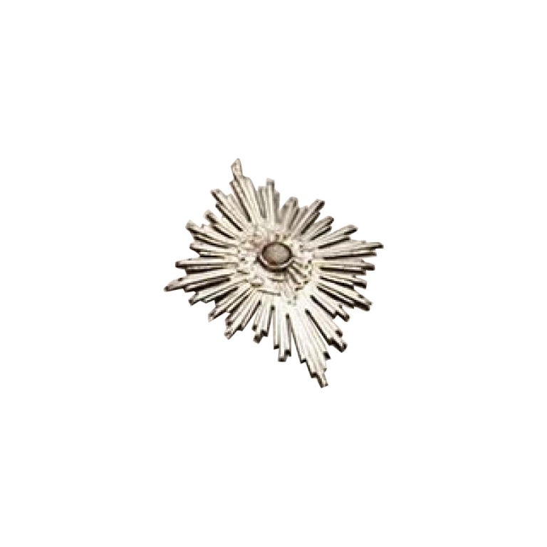 Silver splendor with raised floral motifs surrounding lined stone
