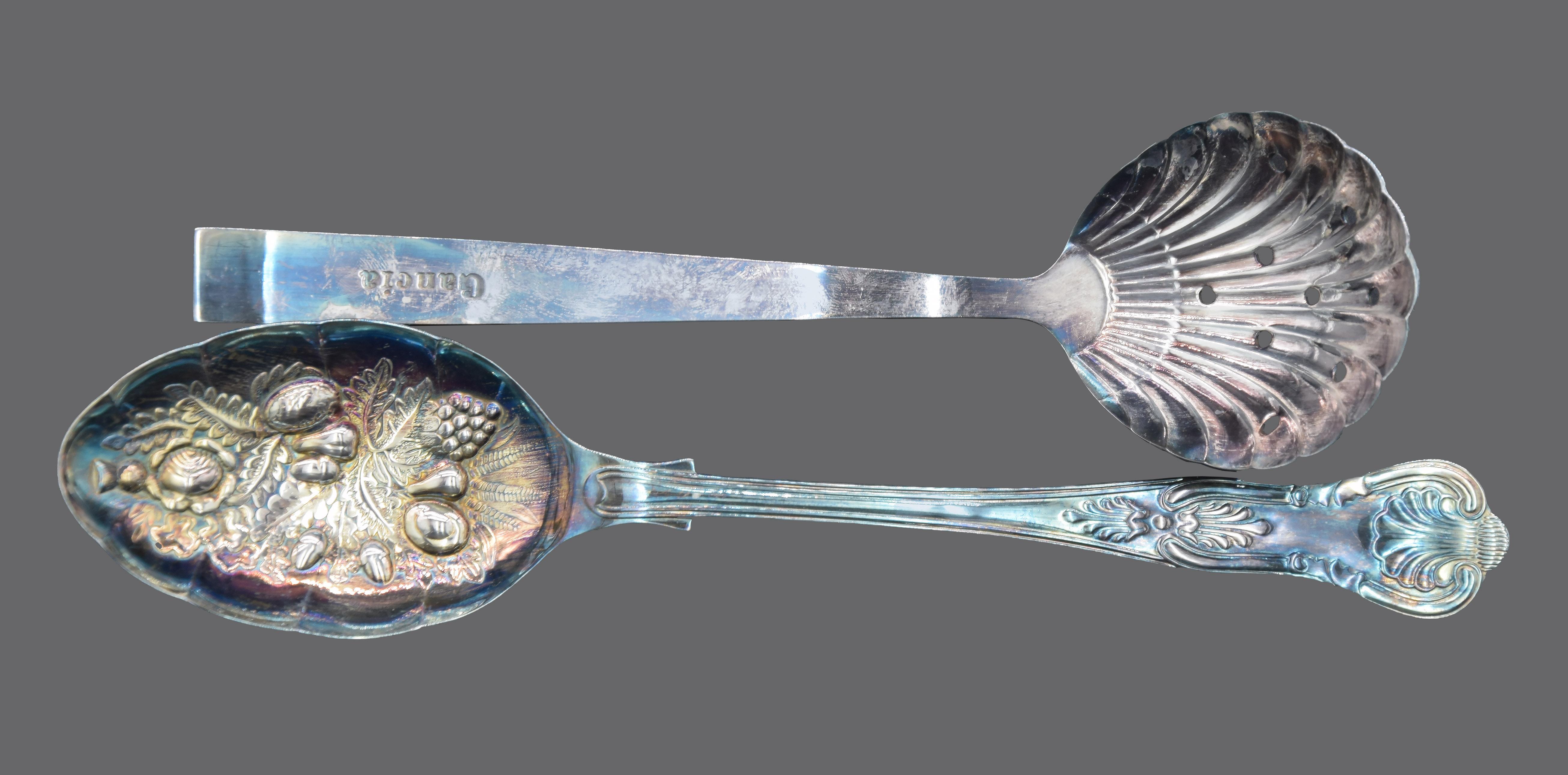 20th century.

The lot consists of two spoons. 

1) Ice spoon perforated shaped shell.

Carved on the front of the handle with the 